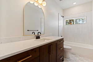 Full bath featuring vanity and shower / bath combination