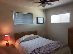 Bedroom featuring a textured ceiling and ceiling fan