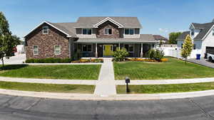 Craftsman house featuring stone siding, roof with shingles, and covered porch