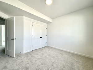 Unfurnished bedroom featuring carpet flooring and baseboards