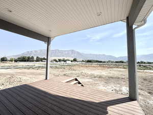 Wooden deck with a mountain view and a view of rural / pastoral area
