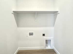 Laundry room featuring electric dryer hookup, hookup for a washing machine, and wood finished floors
