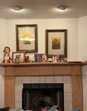 Detailed view of a fireplace and a textured ceiling