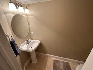 Half bath with tile patterned flooring and a textured ceiling