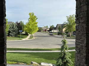 View of asphalt road with sidewalks, a residential view, curbs, and Layton Temple