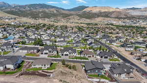 Aerial view of property's location with a mountainous background and nearby suburban area