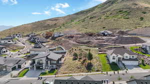 Aerial view of property's location featuring nearby suburban area and a mountain backdrop