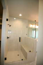 Large shower with sitting bench and lots of light.