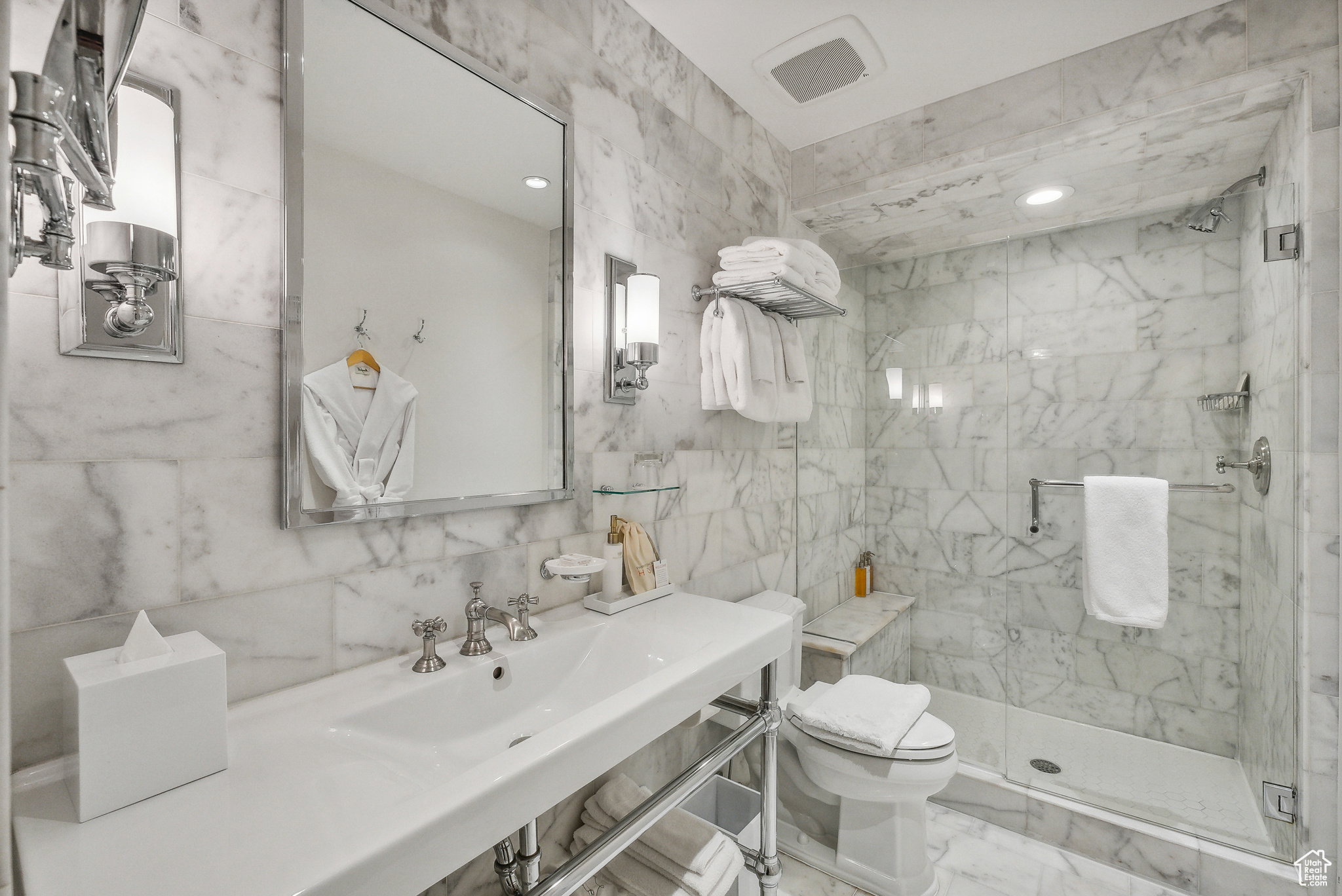 Bathroom with tile walls, a marble finish shower, marble look tiles, and recessed lighting