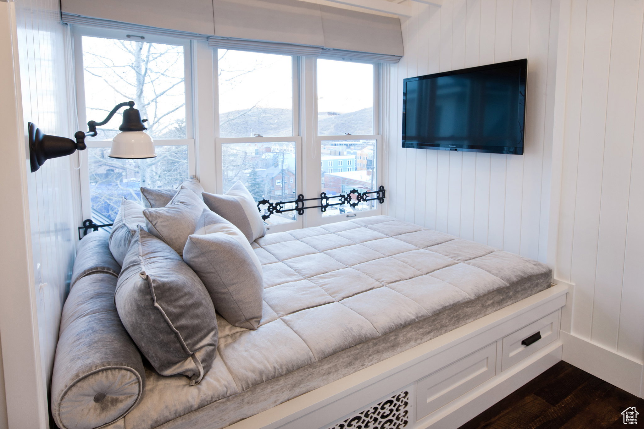 Bedroom with wood walls and dark wood-style floors