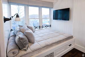Bedroom with wood walls and dark wood-style floors