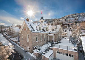 View of front facade with a chimney, an outbuilding, a residential view, and a balcony