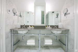 Full bathroom featuring tile walls