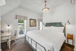 Carpeted bedroom featuring a chandelier