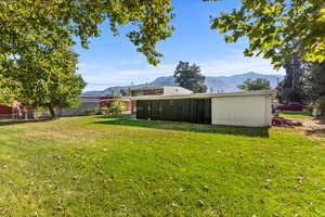 View of yard with a mountain view and a sunroom