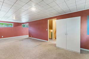 Basement with carpet and baseboards