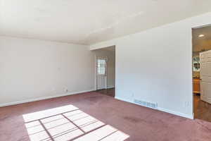Unfurnished room featuring carpet flooring and baseboards