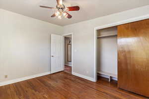 Unfurnished bedroom with wood-type flooring, a closet, and ceiling fan