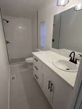 Bathroom featuring vanity and a tile shower
