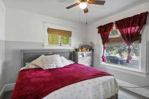 Bedroom featuring baseboards and ceiling fan