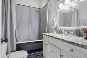 Bathroom with vanity and shower / tub combo