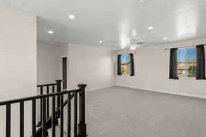Empty room with light carpet, recessed lighting, a ceiling fan, and a smoke detector