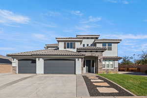 Mediterranean / spanish home featuring stone siding, an attached garage, concrete driveway, stucco siding, and a tiled roof