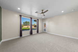 Unfurnished room featuring light colored carpet, ceiling fan, and recessed lighting