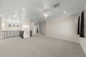 Spare room featuring light carpet, ceiling fan, and recessed lighting