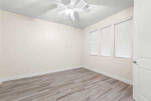 Unfurnished bedroom with light wood-style floors and ceiling fan