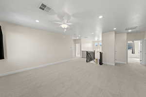 Unfurnished living room with light carpet and recessed lighting