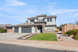 Mediterranean / spanish house with stone siding, concrete driveway, a front lawn, stucco siding, and an attached garage
