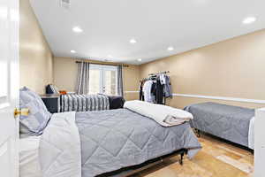 Bedroom with recessed lighting and stone tile floors
