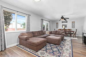 Living area featuring dark wood finished floors and ceiling fan