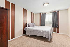 Carpeted bedroom featuring baseboards