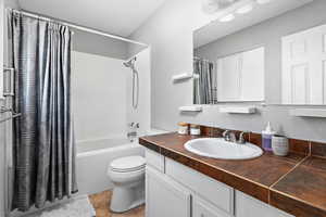 Bathroom featuring vanity and shower / tub combo