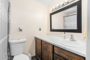 Full bathroom featuring vanity and toilet