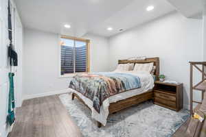 Bedroom featuring wood finished floors and recessed lighting
