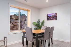 Dining space featuring light wood-style flooring and recessed lighting