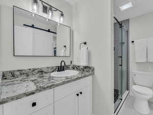 Bathroom featuring vanity, a stall shower, and tile patterned flooring