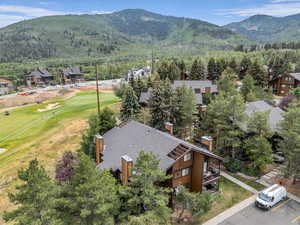 Aerial view of a mountainous background and a local golf course