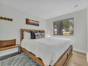 Bedroom featuring baseboards and wood finished floors