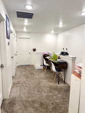 Office featuring carpet floors and a textured ceiling