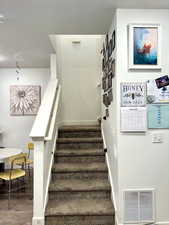 Stairs with baseboards and wood finished floors