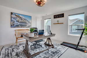 Carpeted home office with baseboards