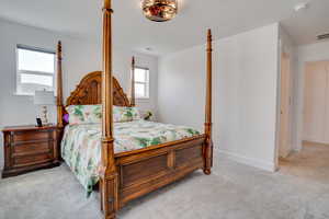 Carpeted bedroom featuring baseboards