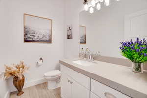Bathroom featuring vanity and wood finished floors