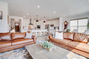 Living room with light wood-style floors and recessed lighting