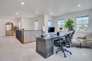 Office space featuring plenty of natural light, light carpet, recessed lighting, and a textured ceiling