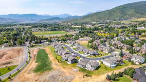 Aerial perspective of suburban area featuring a mountainous background
